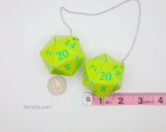 Neon green twenty-sided dice car charms with blue numbers, shown beside a ruler and coin for size.