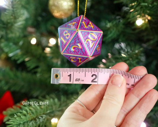 Holographic twenty-sided dice ornament measured with a tape, hanging on a Christmas tree