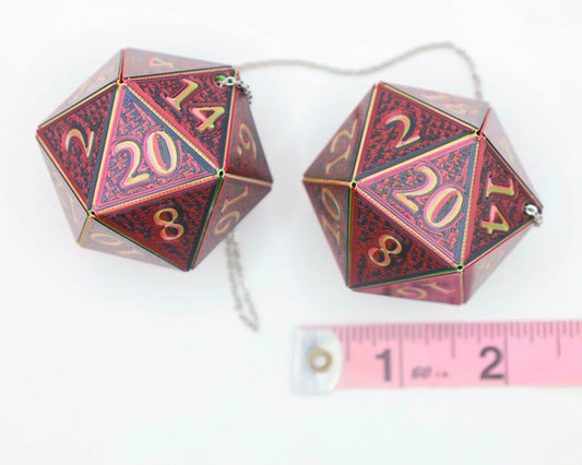 Pair of large red holographic 20-sided dice car charms with chain, shown next to ruler