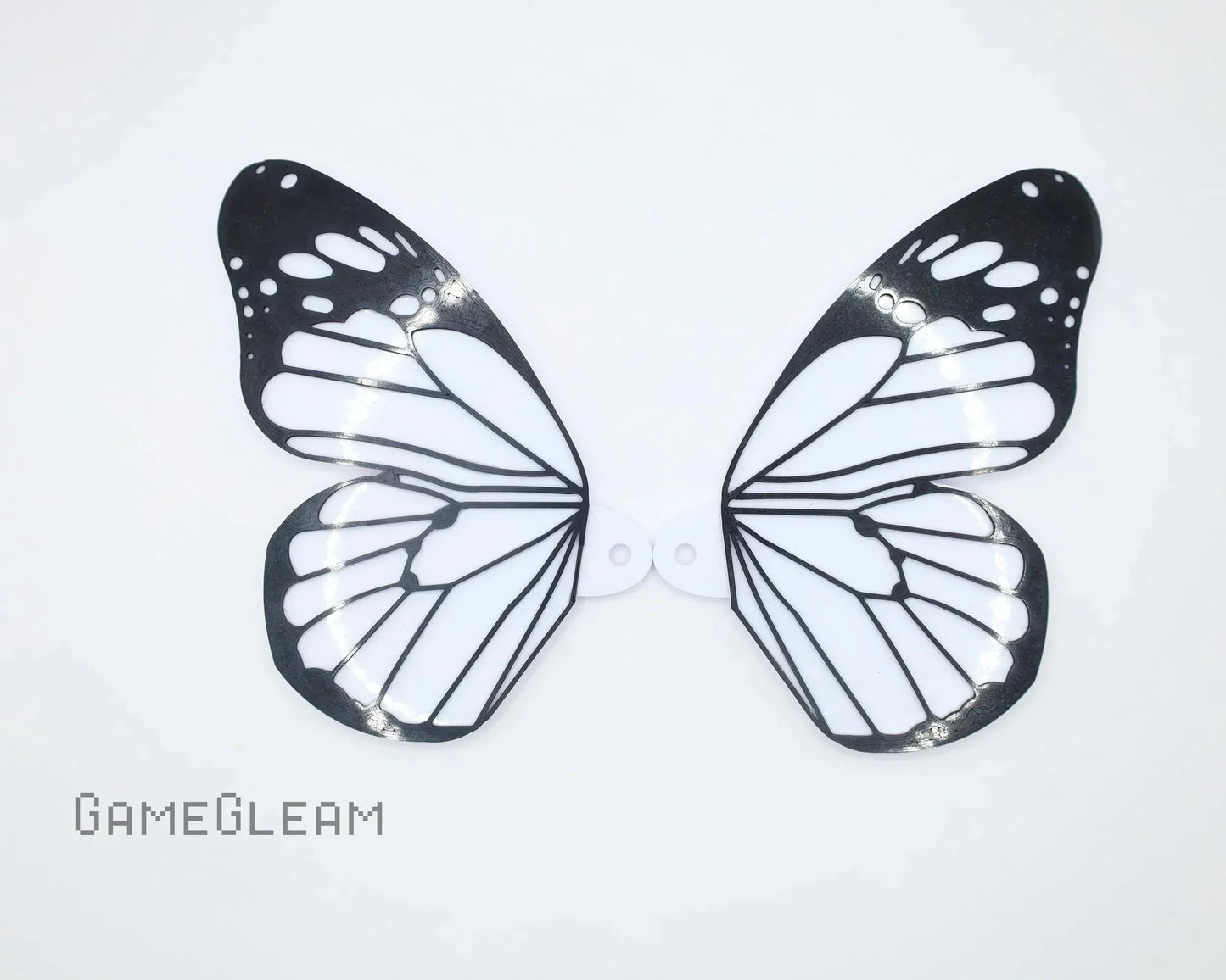 Black and white butterfly wing car charm accessory on white background