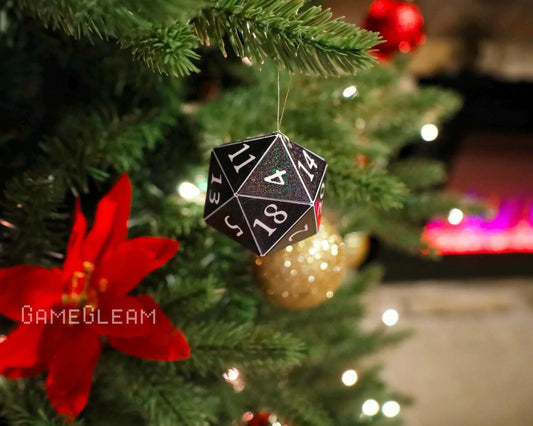 Holographic black twenty-sided dice ornament hanging on a decorated Christmas tree