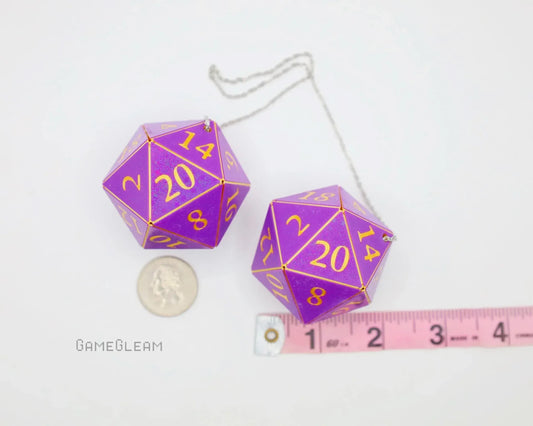 Purple 20-sided dice car charm with gold numbers, shown beside a coin and ruler for scale.