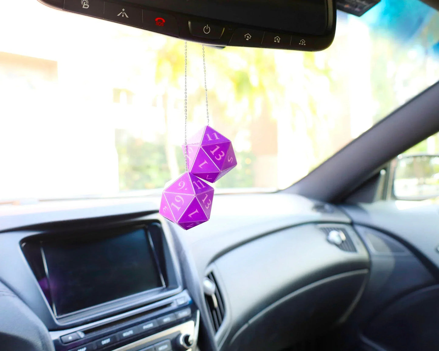 Purple twenty-sided dice car mirror charm for tabletop RPG fans, hanging in a modern car interior