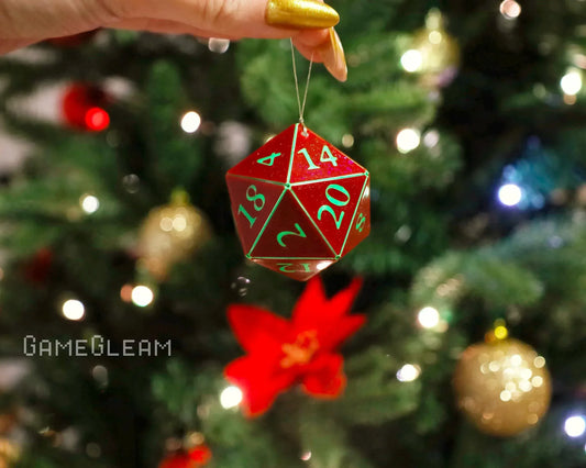 Red and green twenty-sided dice Christmas tree ornament held by hand, festive background