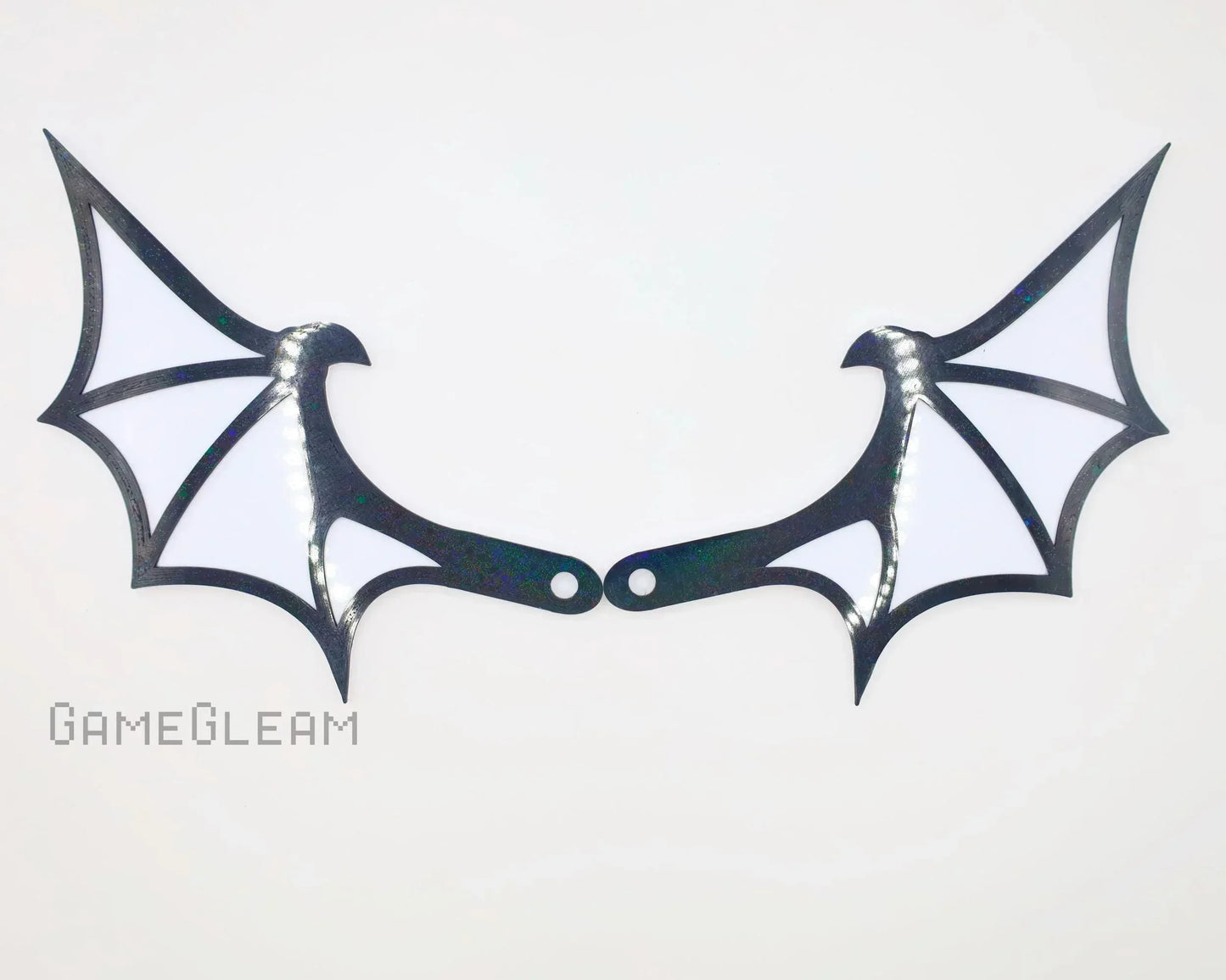 Pair of holographic black and white bat wing shaped car mirror charms on white background