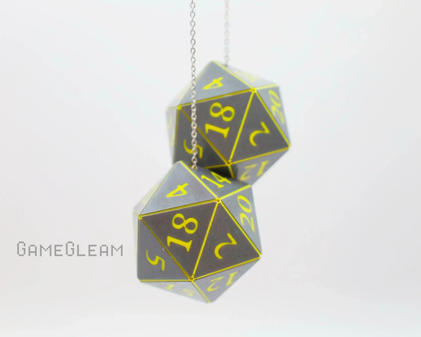 Pair of holographic twenty-sided dice car charms with yellow numbers on silver chain