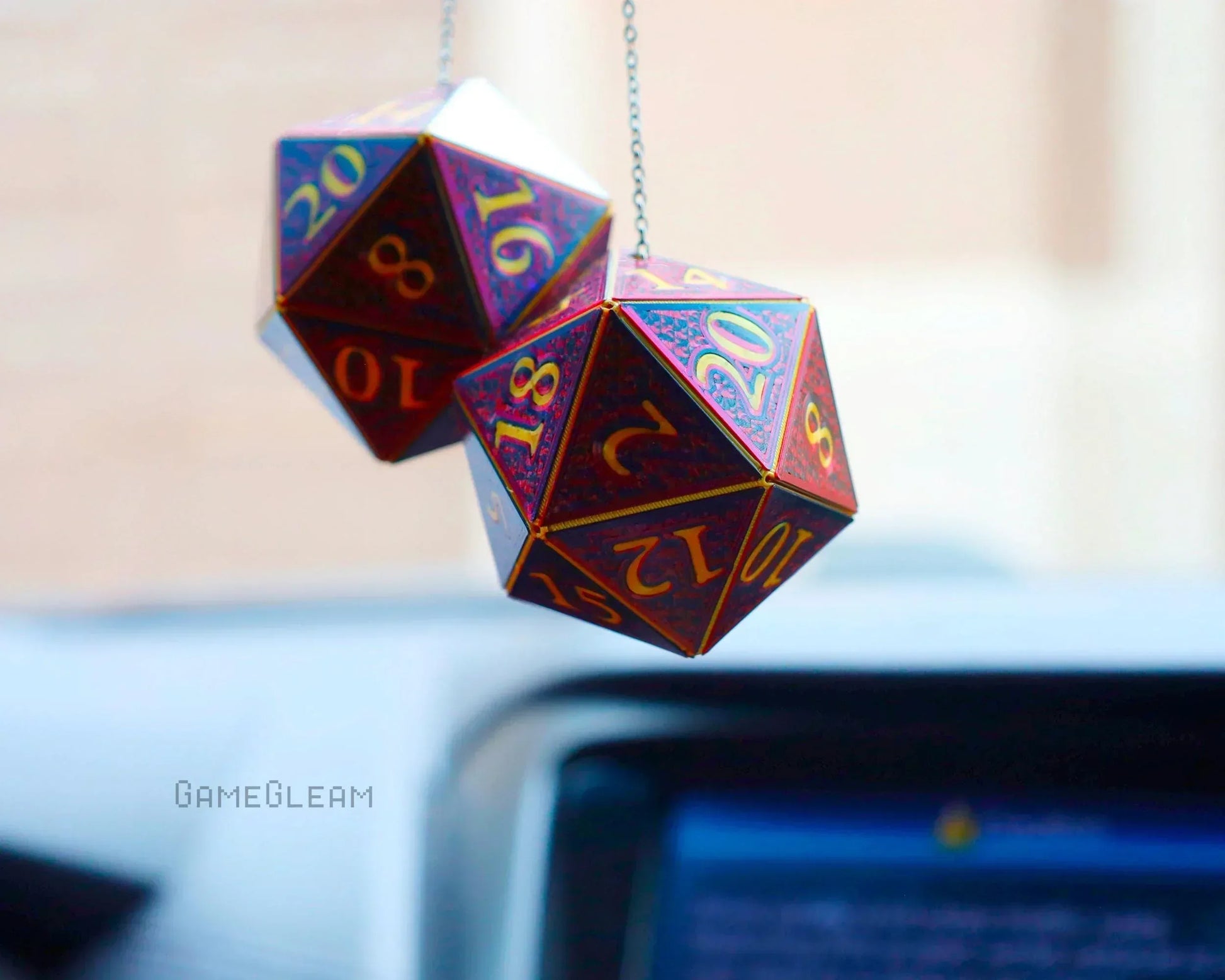 Holographic red polyhedral dice car charm for tabletop RPG fans hanging from rearview mirror