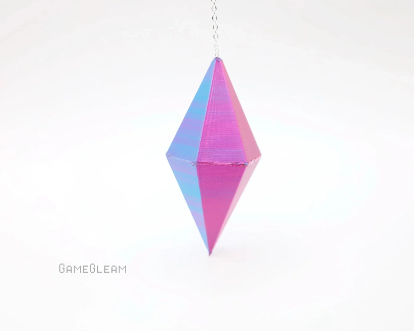 Holographic pink and blue geometric hanging charm with chain on white background