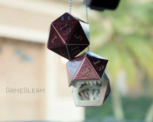 Red holographic 20-sided dice car charm with a dragon mouth design hanging from a mirror
