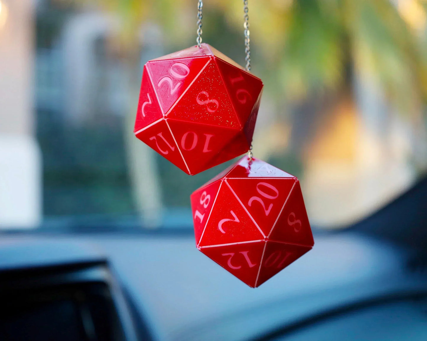 Red 20-sided dice car charm hanging on a chain, perfect for tabletop RPG fans.