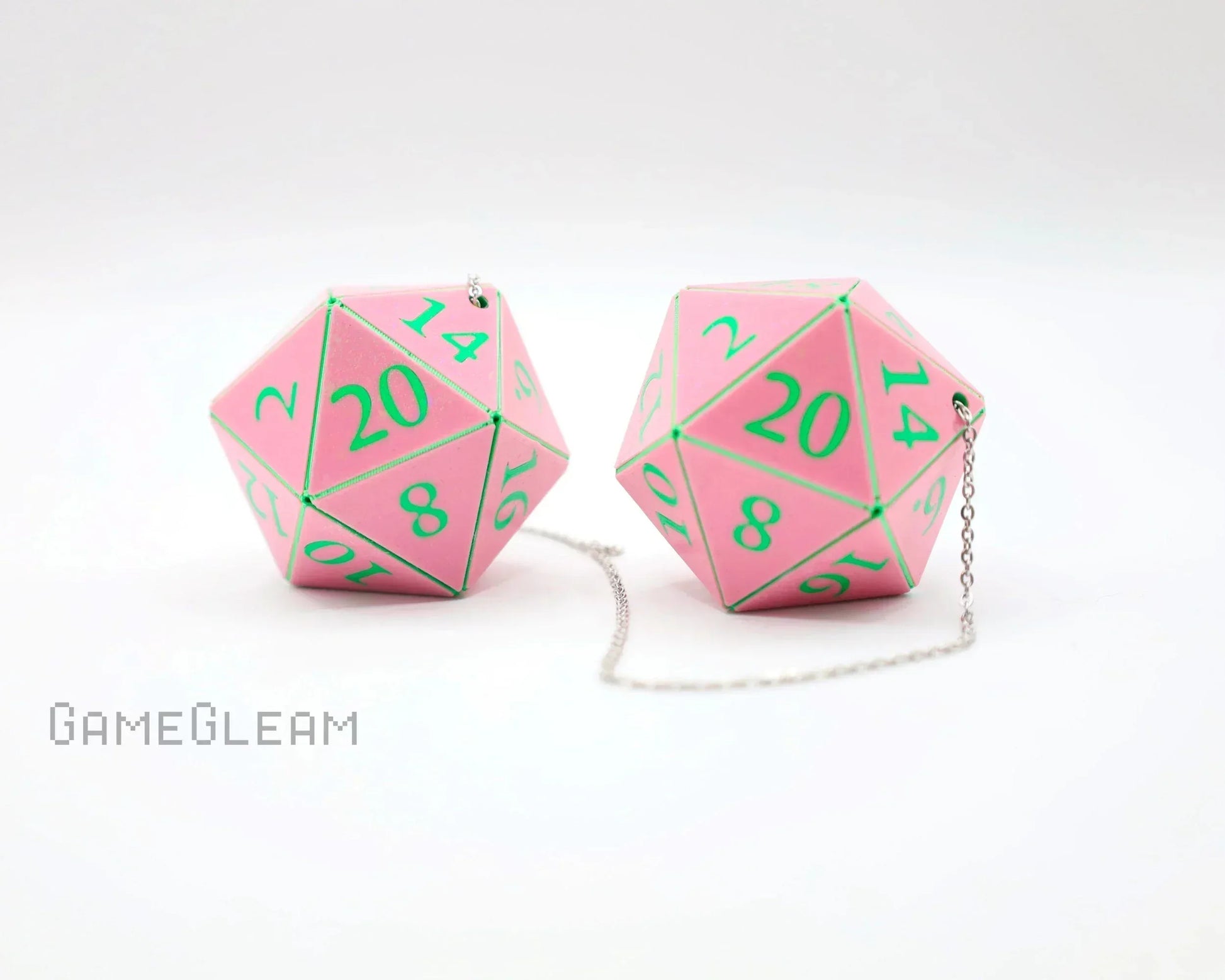 Pink twenty-sided dice with green numbers on a chain, gamer car accessory.