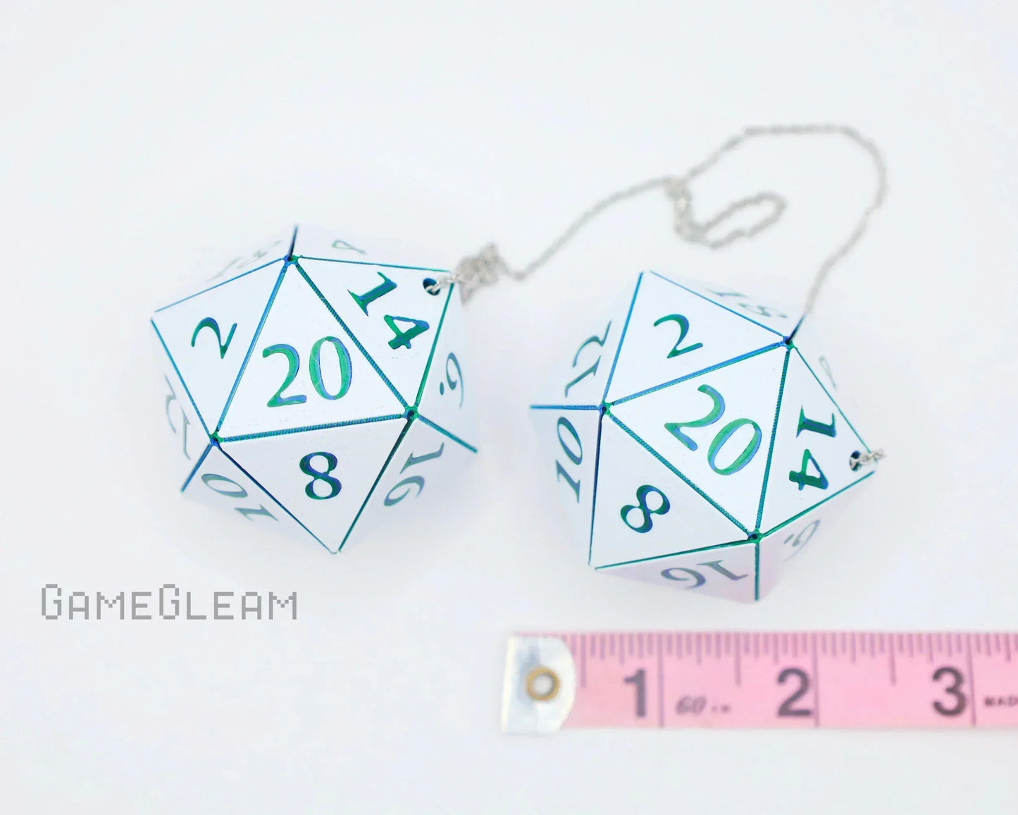 Pair of large holographic twenty-sided dice car charms with chain and ruler for scale