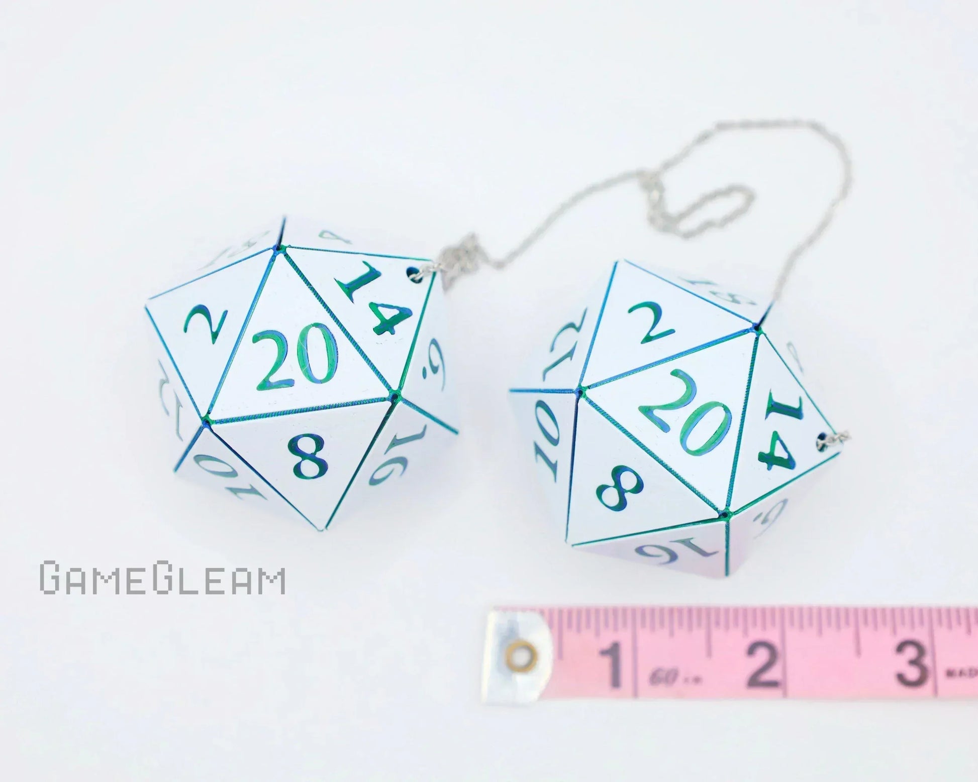 Pair of large holographic twenty-sided dice car charms with chain and ruler for scale