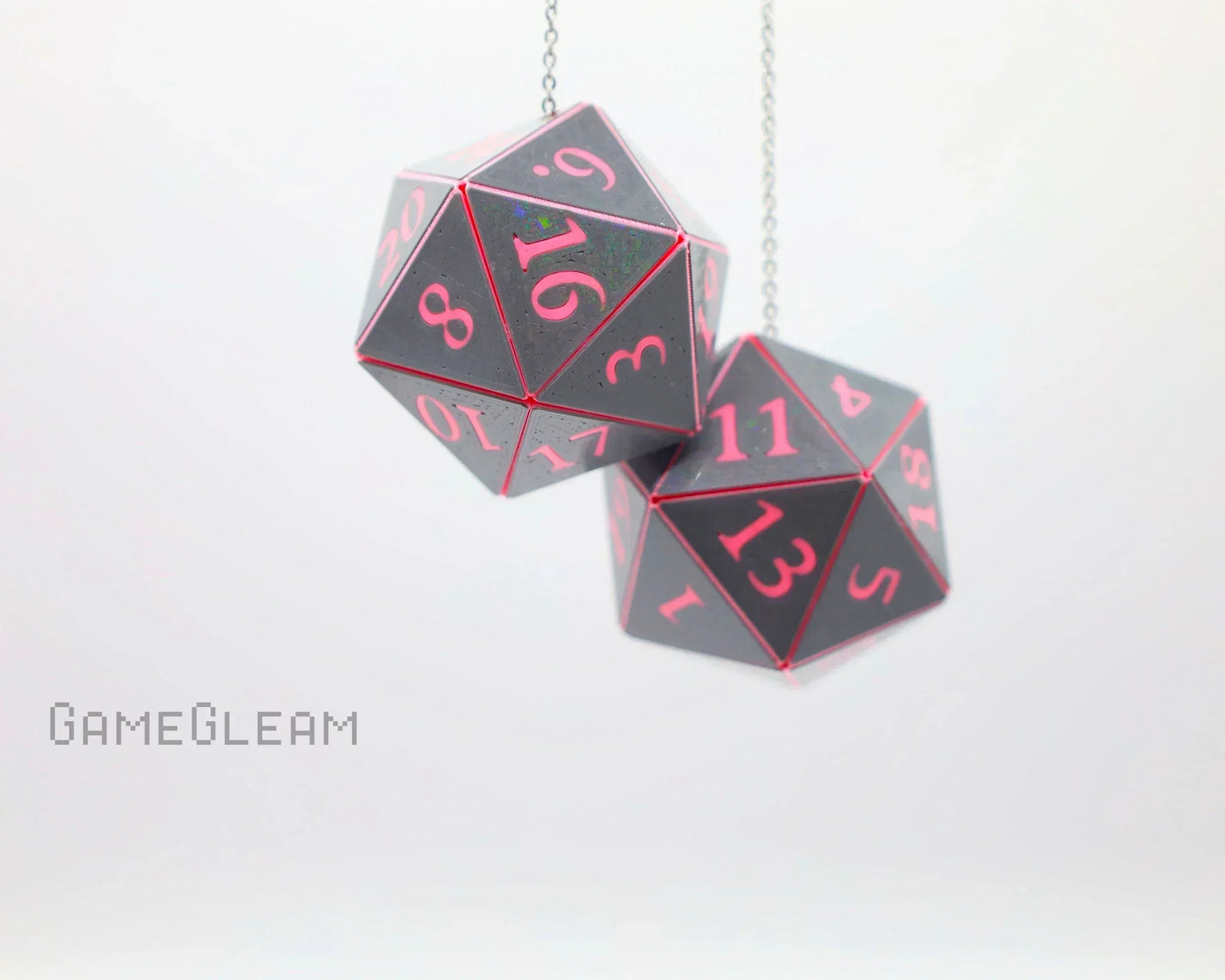 Holographic black and pink 20-sided dice car charm hanging on a chain