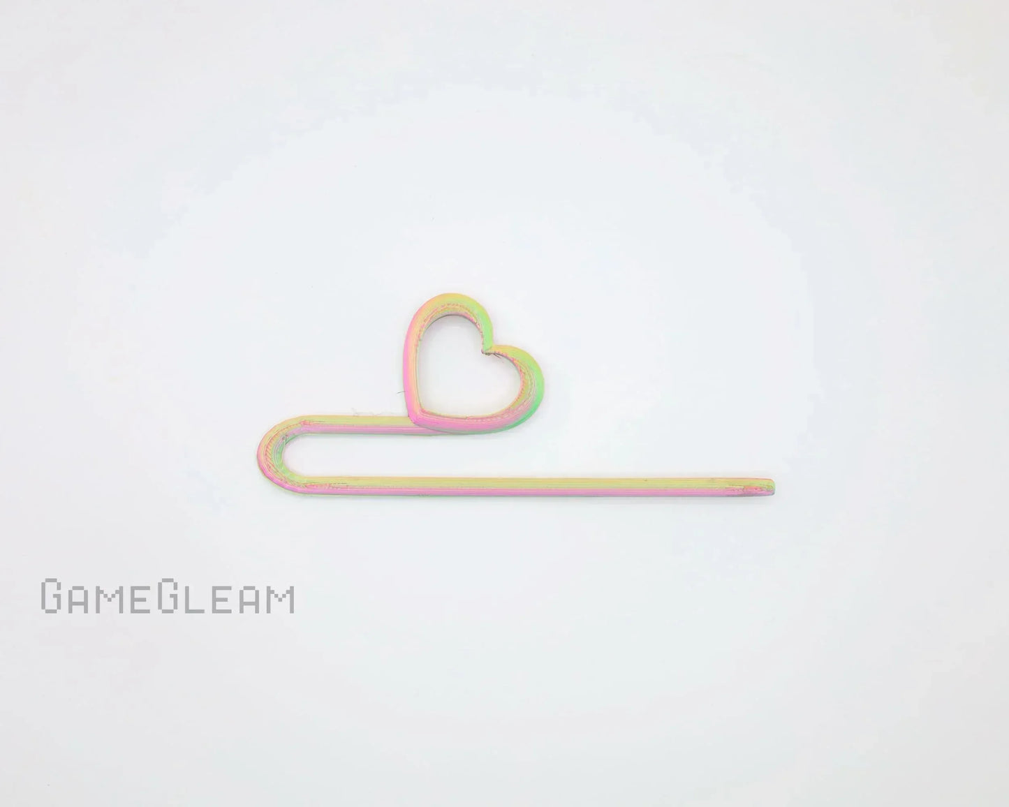 Pastel rainbow heart-shaped hair pin on white background