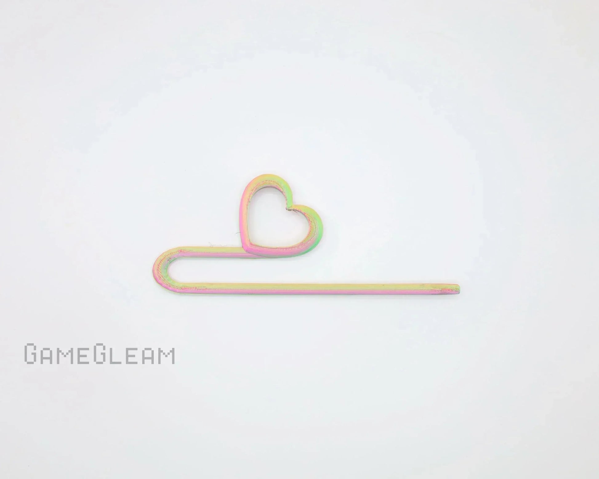 Pastel rainbow heart-shaped hair pin on white background