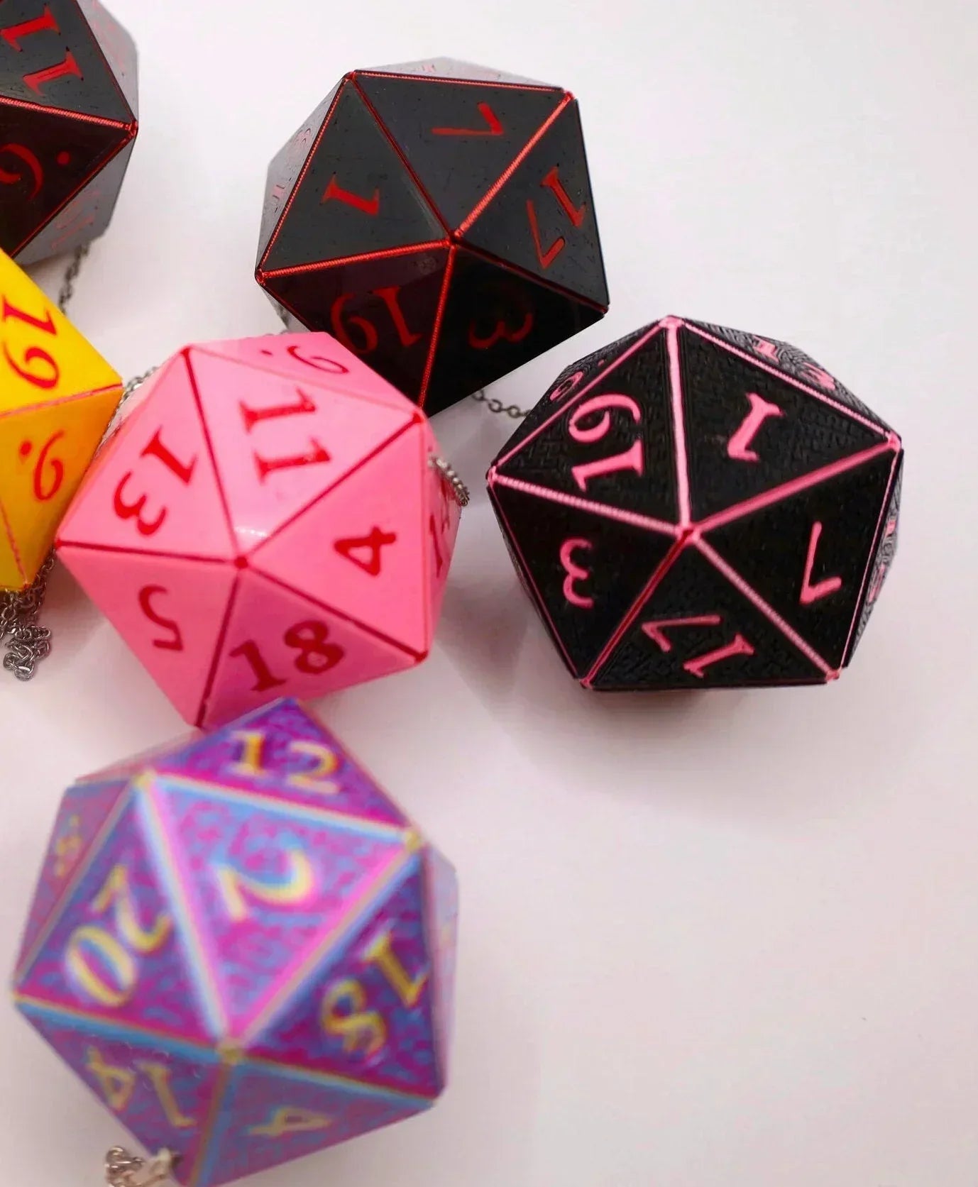 Colorful 20-sided dice charms with vibrant numbers for tabletop gaming accessories