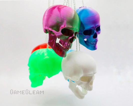Colorful handmade skull car dice charms in green, pink, blue, white, and red on chains