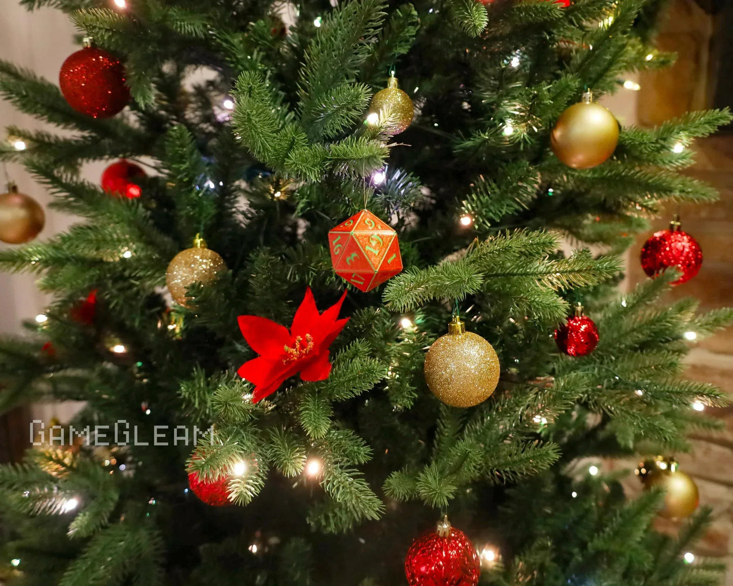 Christmas tree with red and gold ornaments, lights, and a large red twenty-sided dice ornament