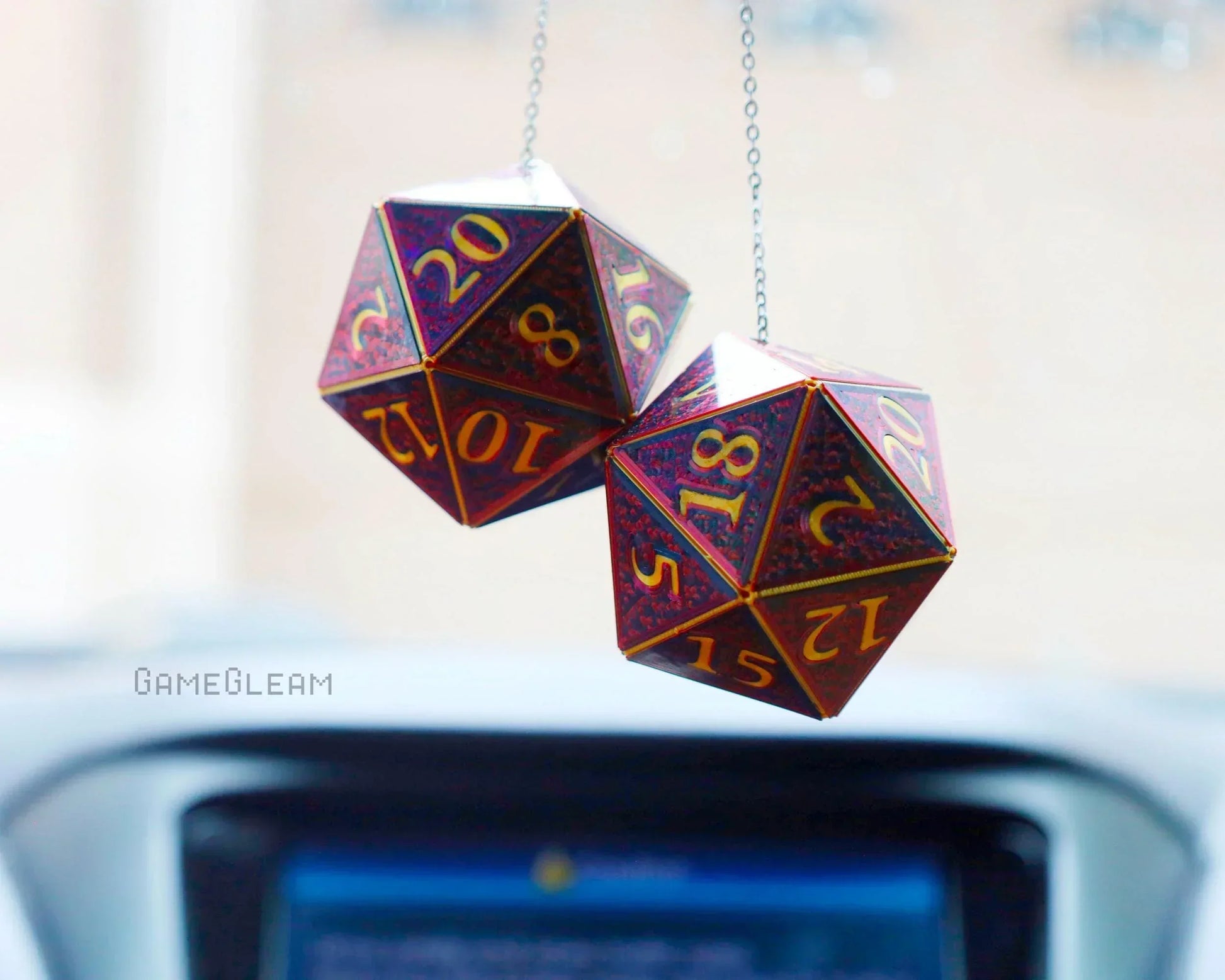 Holographic red and gold 20-sided dice hanging as car mirror charms, ideal gamer gift