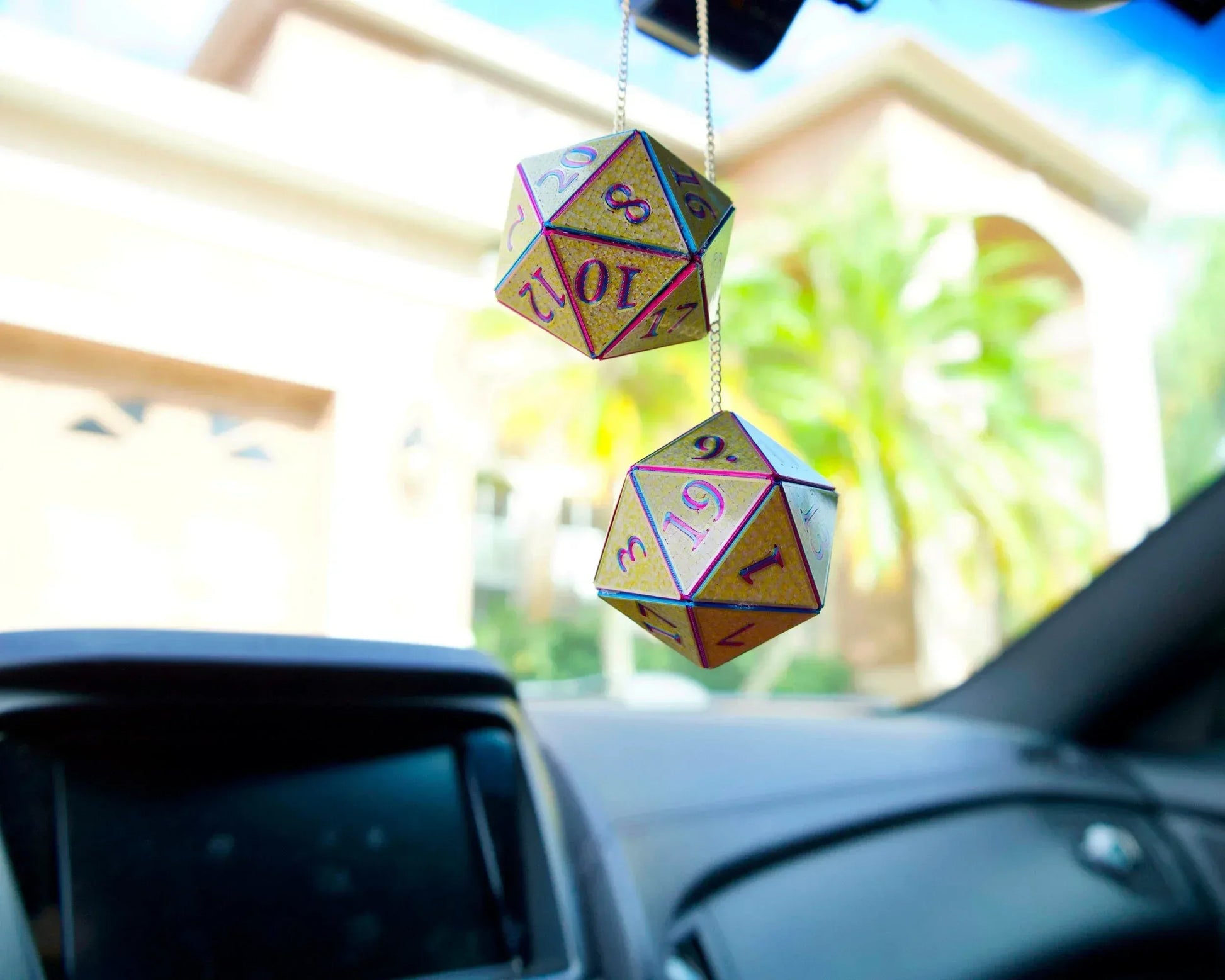 Holographic twenty-sided dice hanging from a car mirror, ideal gamer car accessory gift