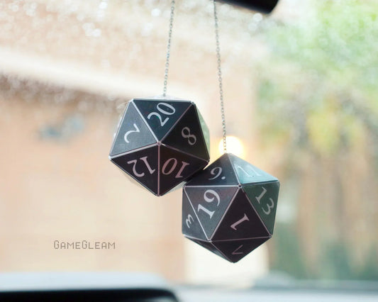 Pair of large black twenty-sided dice car charms hanging from a rearview mirror