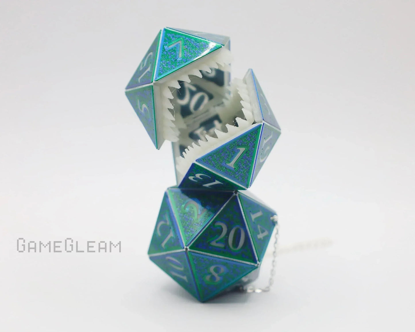 Holographic blue polyhedral dice car charm with sharp teeth and keychain, gaming accessory.