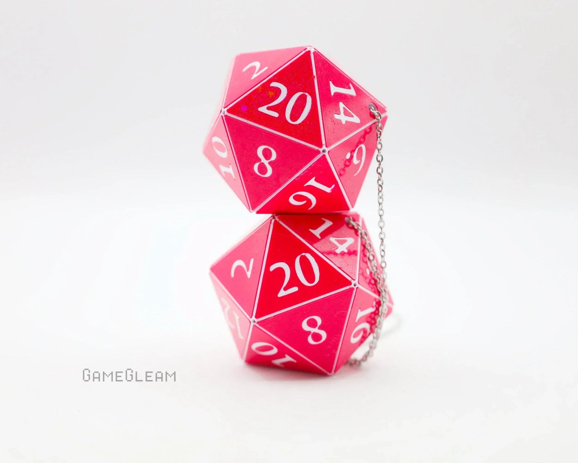 Pink holographic twenty-sided dice car charm with silver chain on a white background