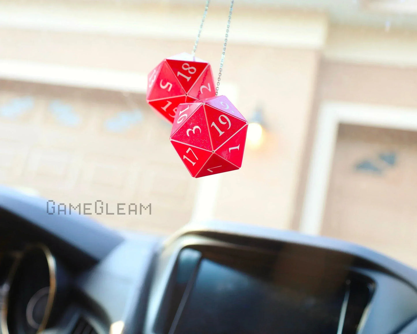 Red twenty-sided dice car charm hanging from rearview mirror, gamer car accessory