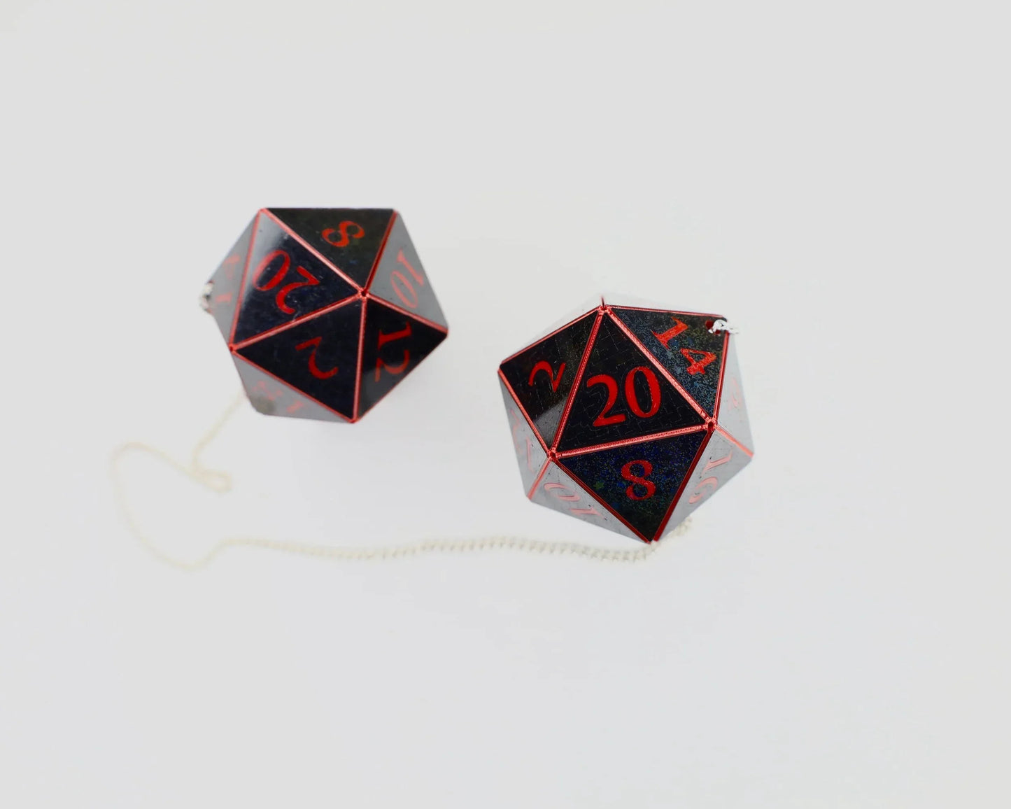 Black and red twenty-sided dice car charm set with chain on a light background