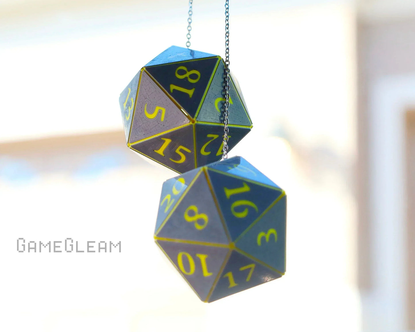 Holographic twenty-sided dice car charm with yellow numbers, hanging on a chain