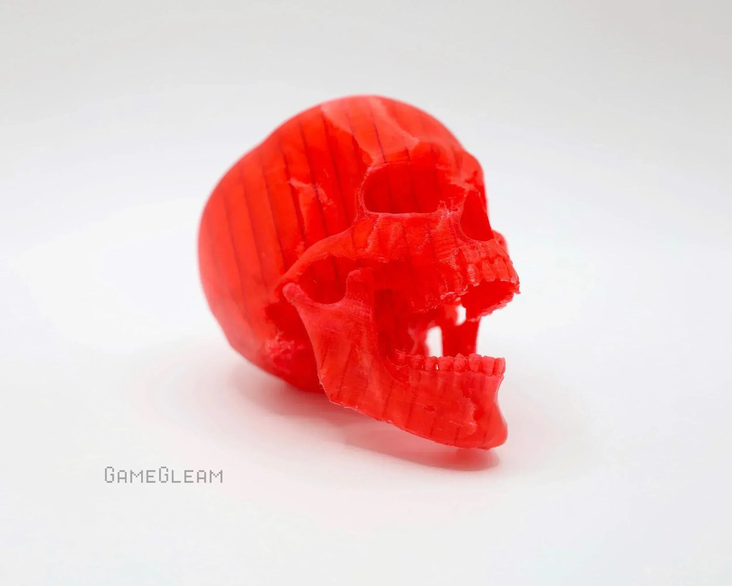 Red 3D printed skull tabletop gaming accessory on white background