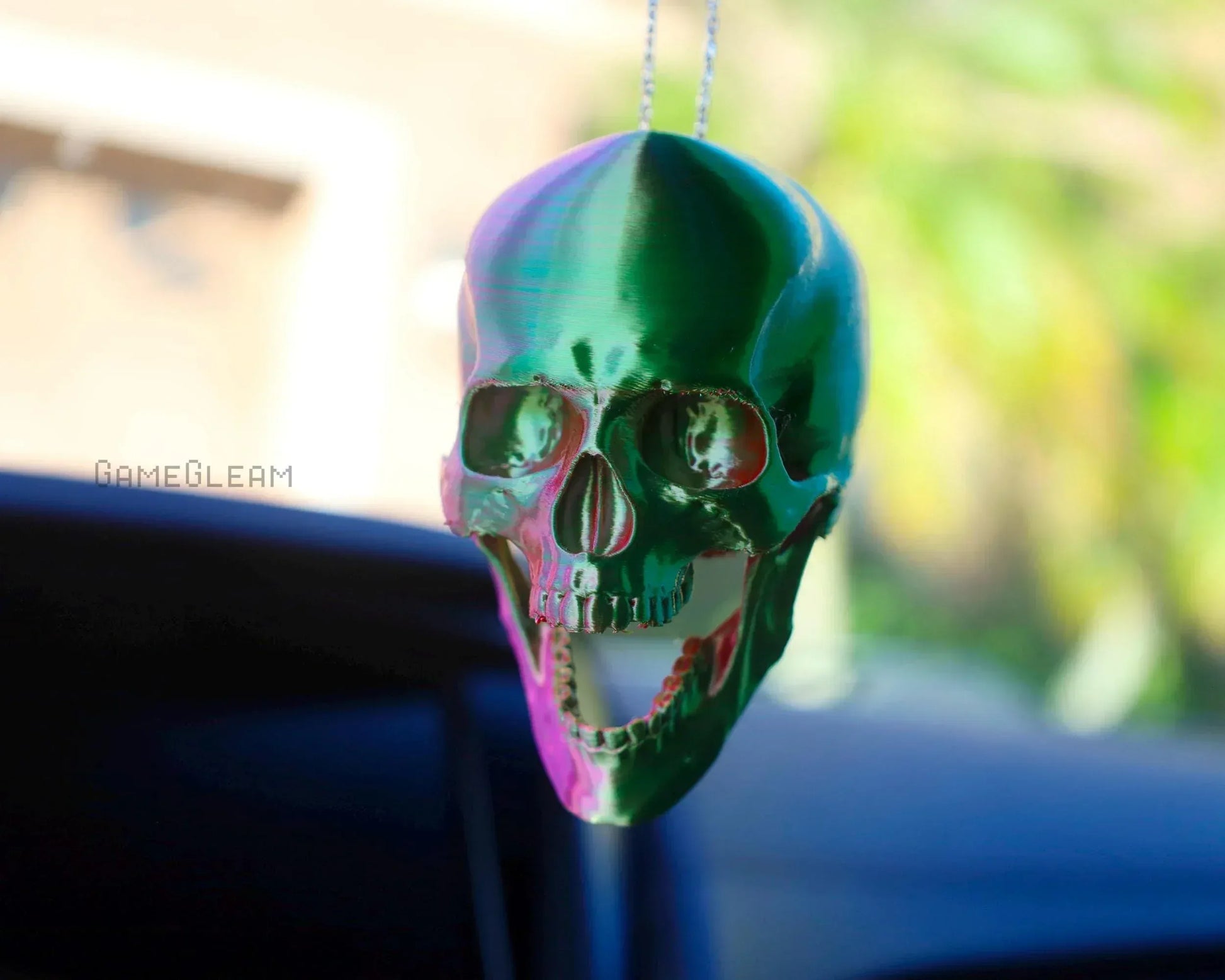 Holographic green skull car charm hanging from rearview mirror, handmade gift accessory