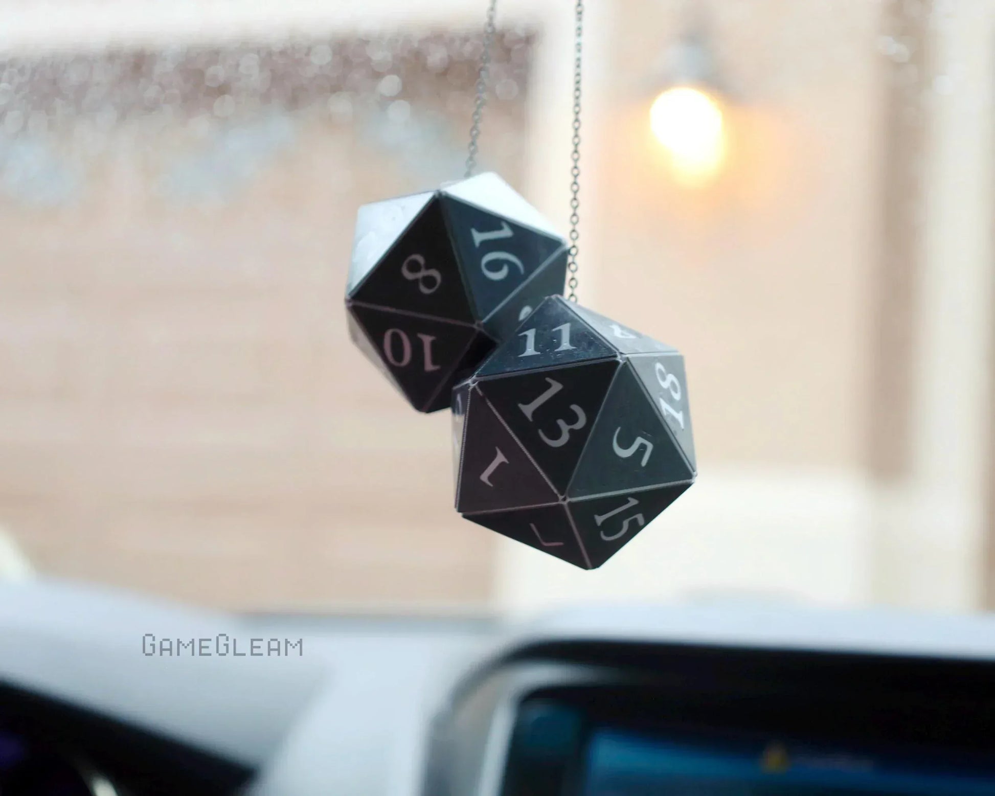 Pair of black 20-sided dice car charms hanging from rearview mirror, gamer car accessory