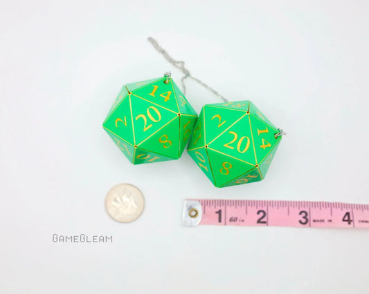 Large green twenty-sided dice car charm with gold numbers, next to a coin and ruler for scale