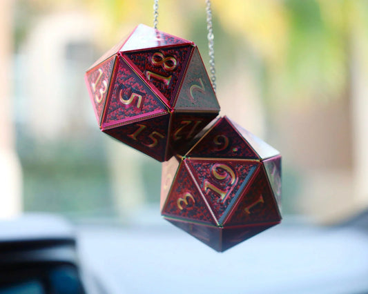 Holographic red twenty-sided dice car charm hanging from rearview mirror
