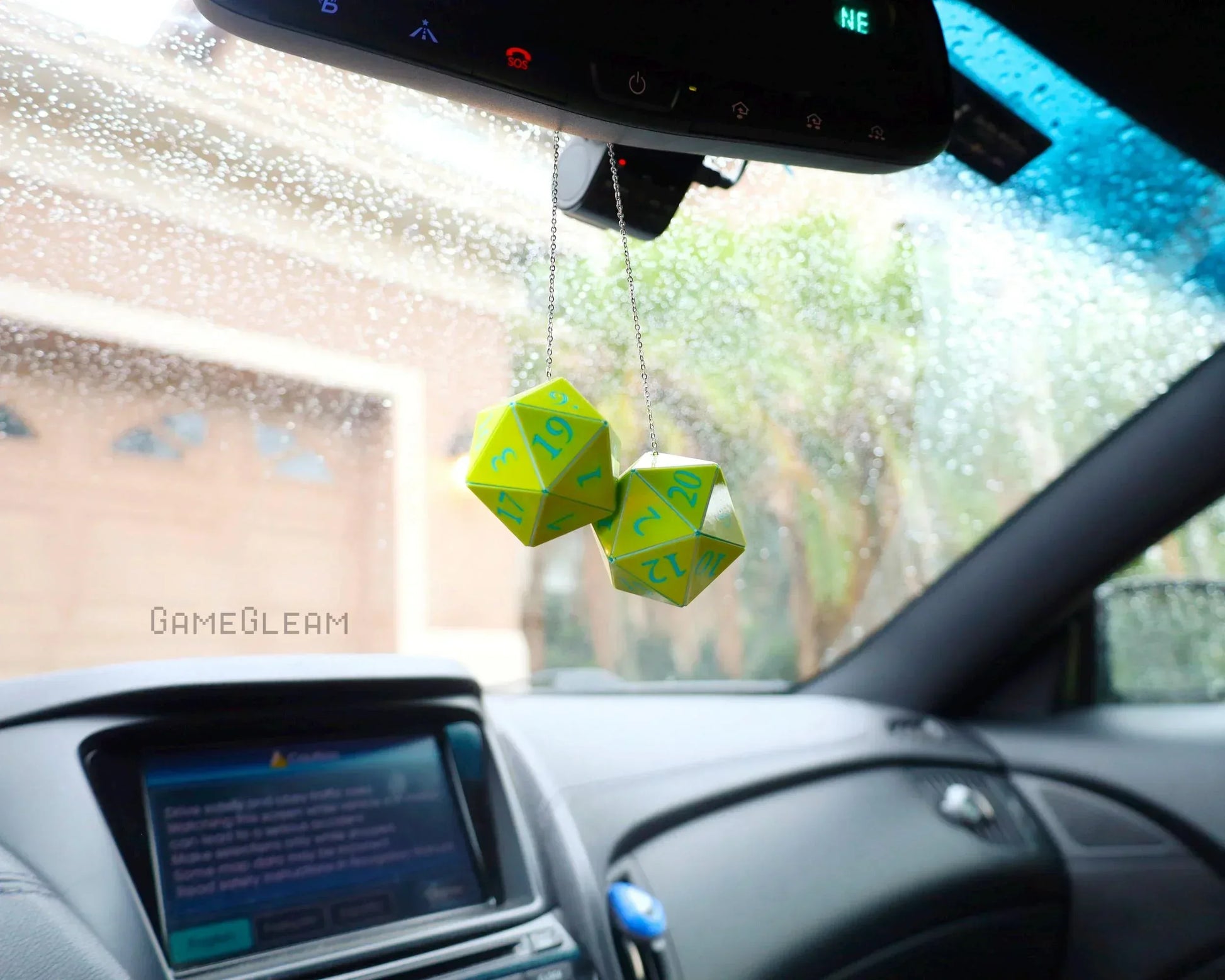 Neon green twenty-sided dice hanging as car mirror charm, interior gamer accessory