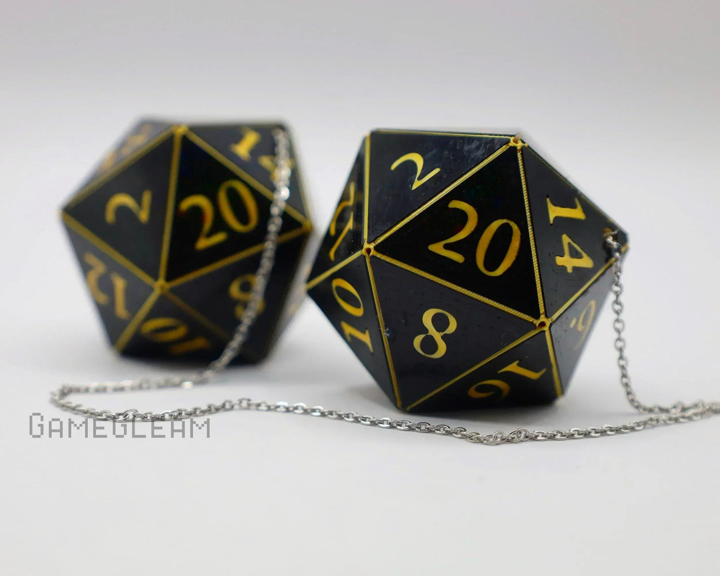 Black and gold 20-sided dice car charms with chain on white background