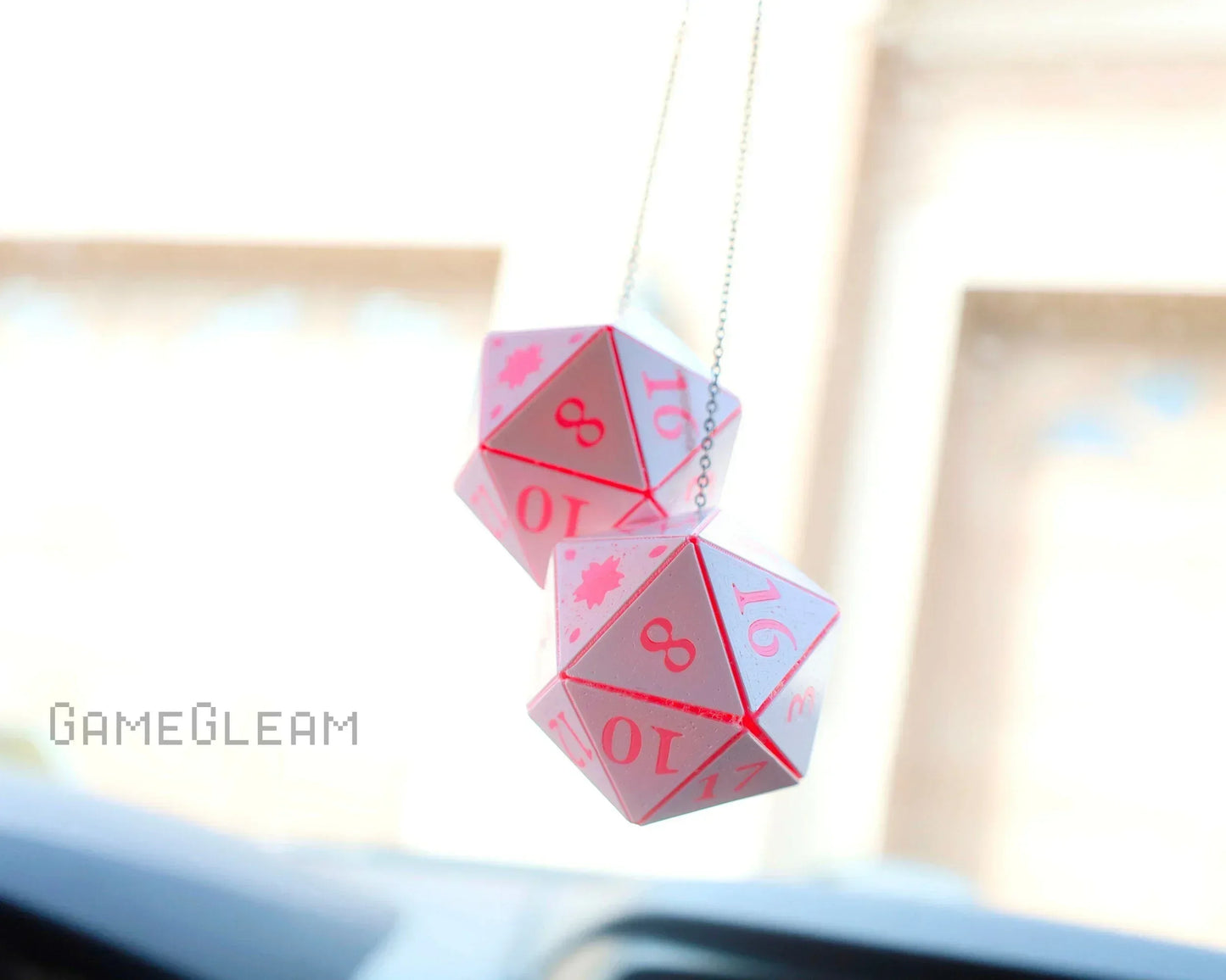 Pink twenty-sided dice hanging from a car mirror, handmade gamer car accessory.