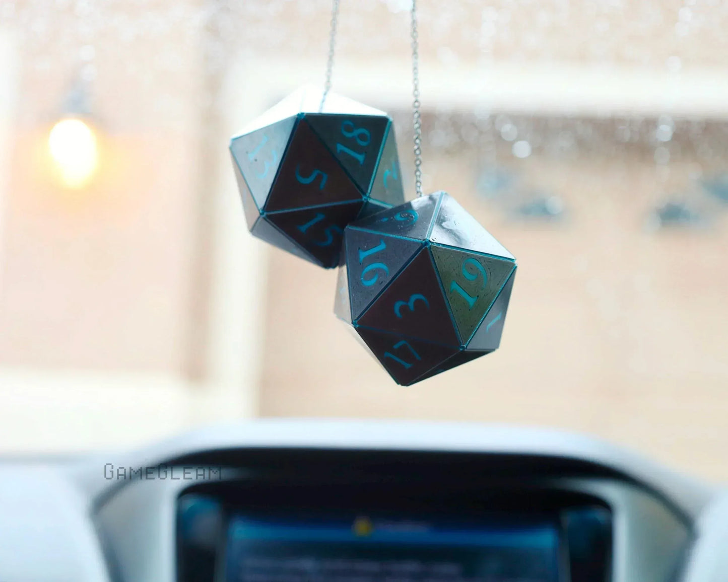 Holographic twenty-sided dice hanging charm for car rearview mirror, rainy background