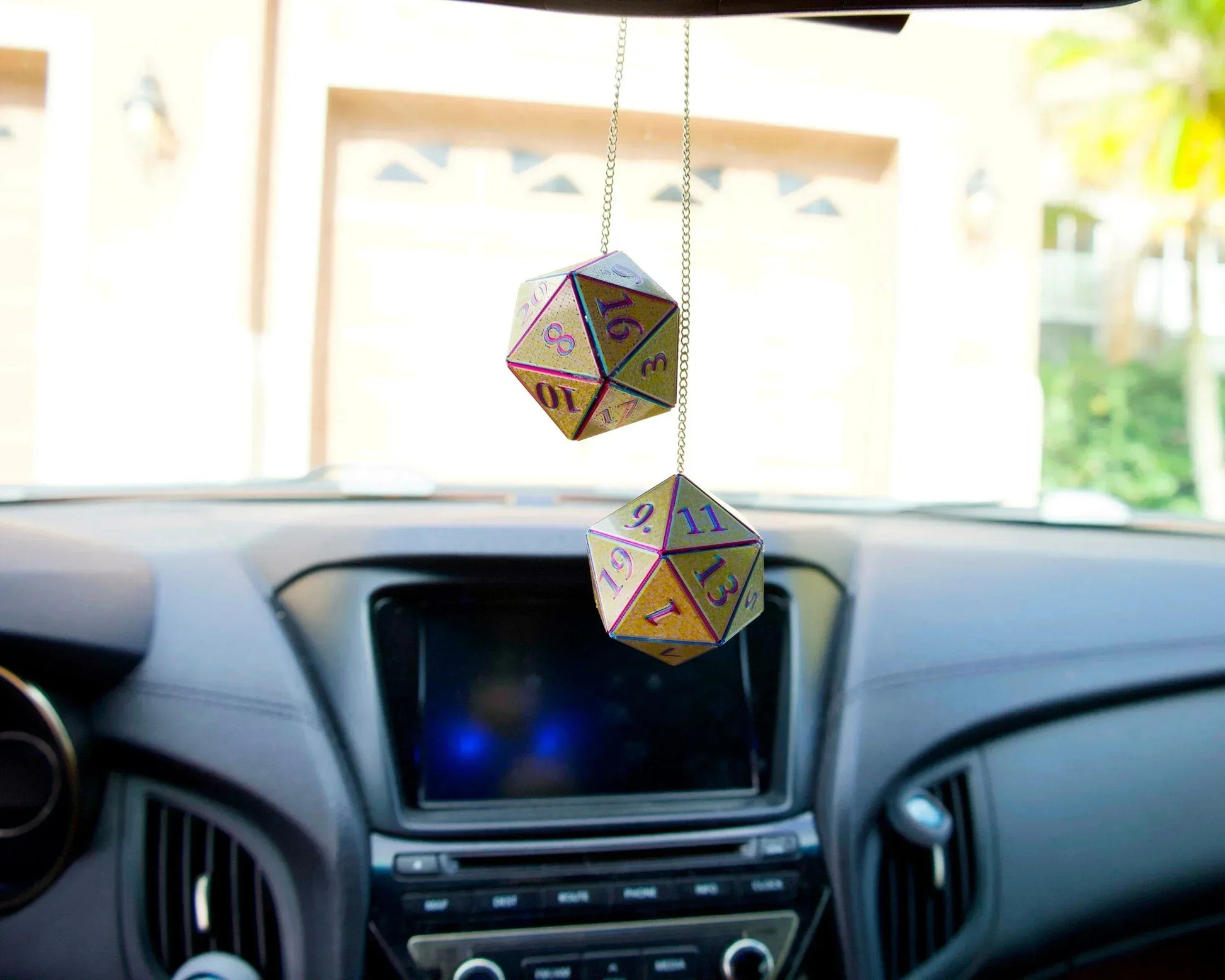 Holographic twenty-sided dice car hanging charm in a car interior for tabletop gamers
