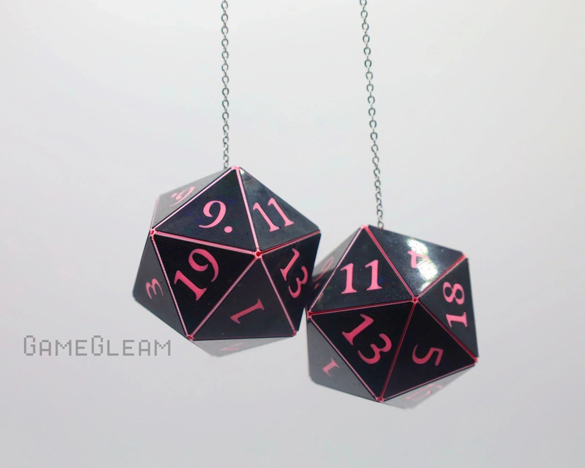 Black and pink twenty-sided dice car charms hanging from chains, gamer gift accessory