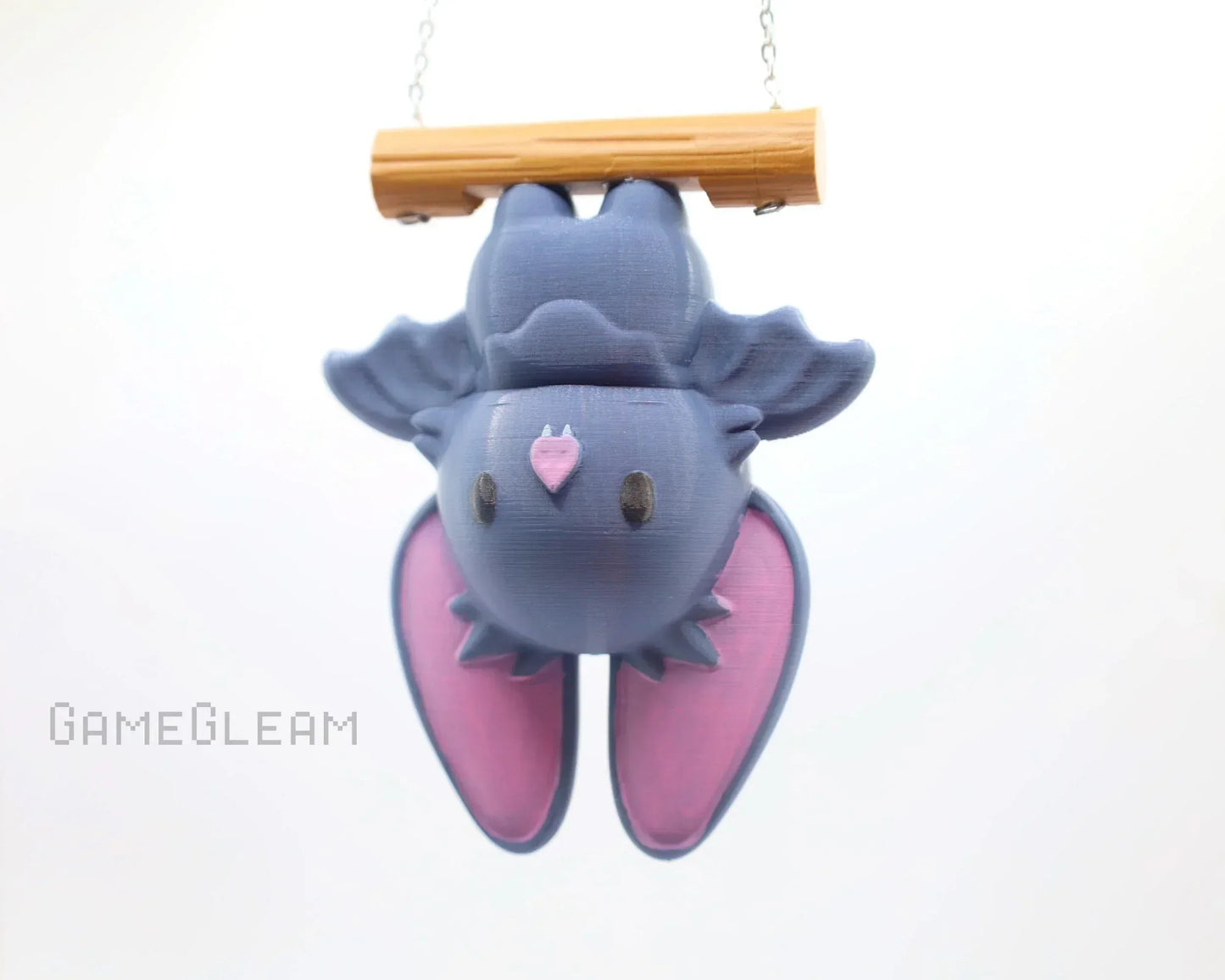Handmade cute purple bat charm hanging upside down with pink wings, perfect for RPG fans