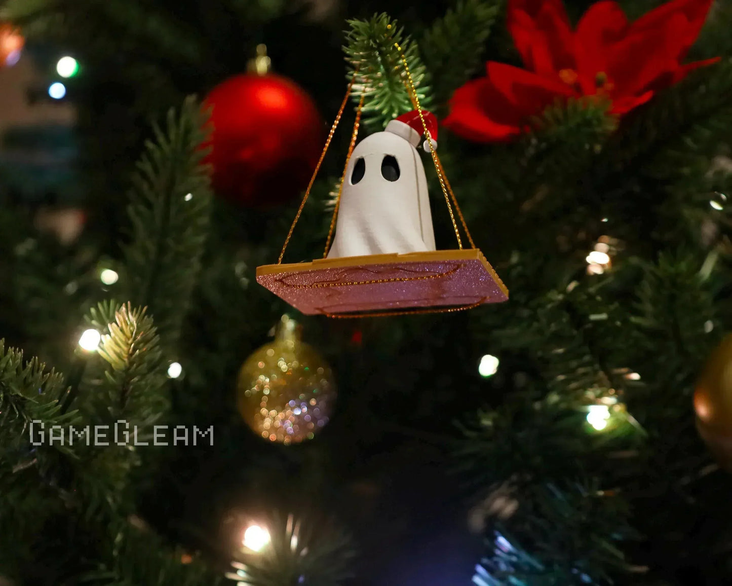 Ghost figurine Christmas ornament in a UFO on a decorated tree with lights and baubles