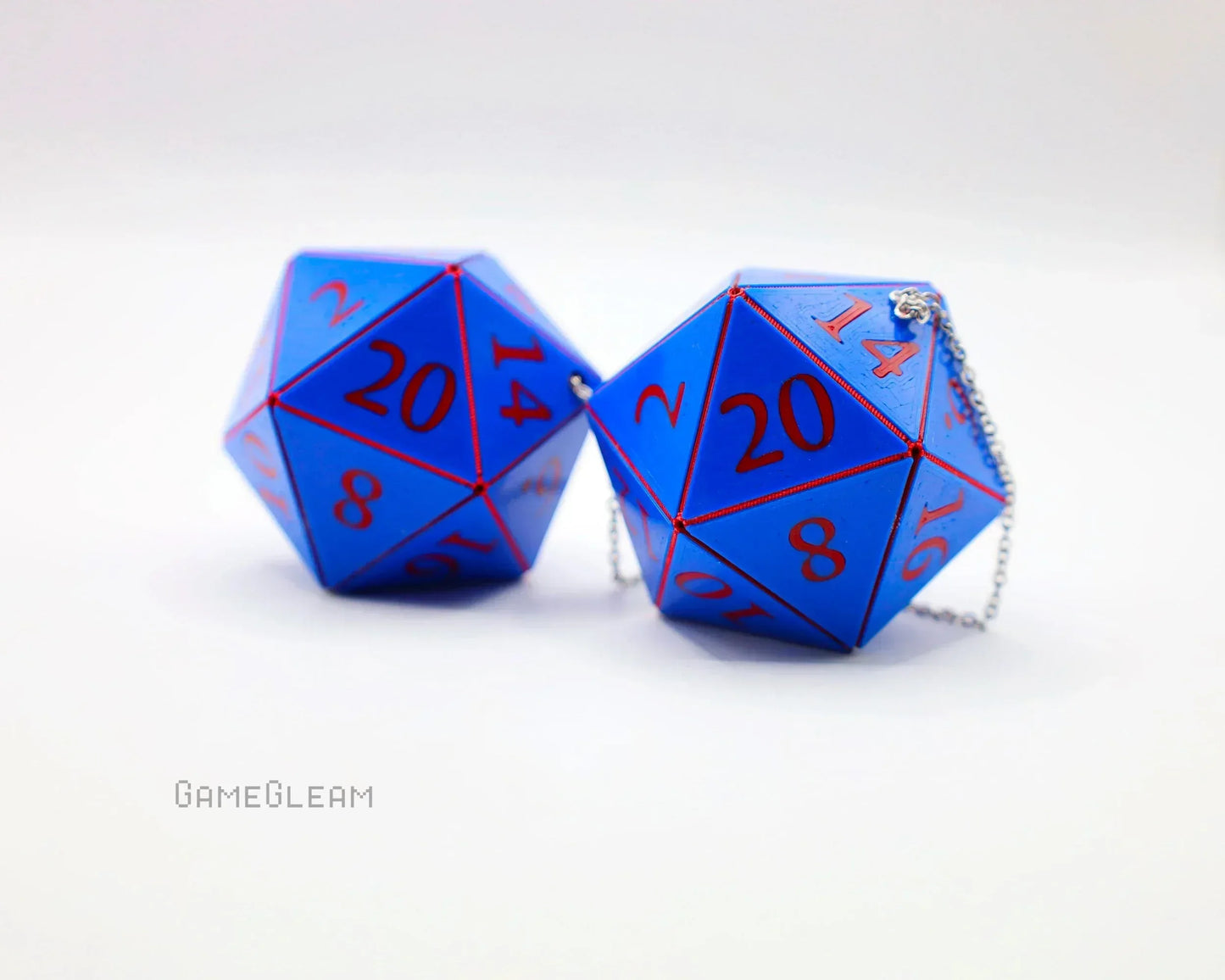 Blue twenty-sided dice car charms with red numbers and silver chains on white background