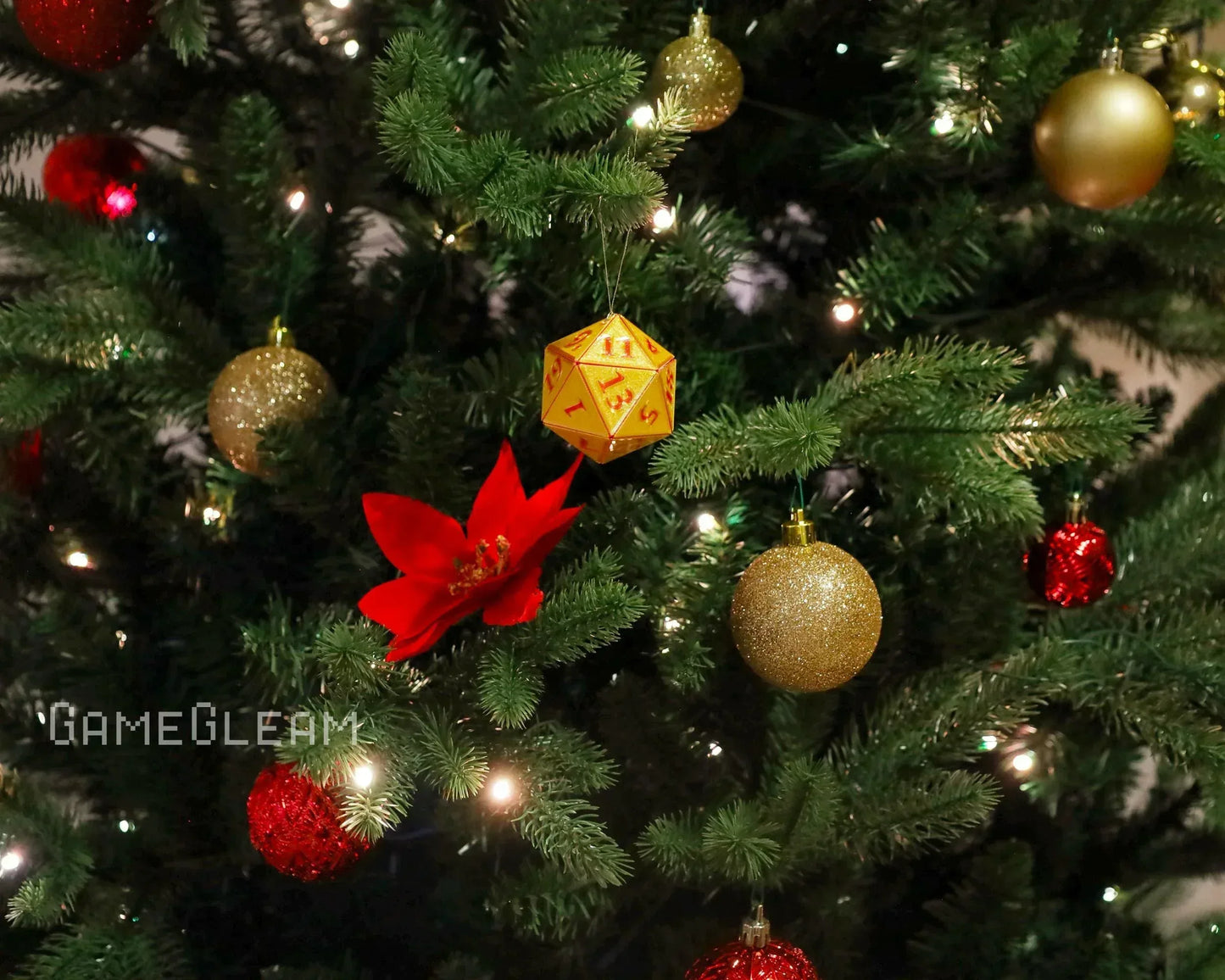 Yellow twenty-sided dice ornament on a decorated Christmas tree with gold and red baubles