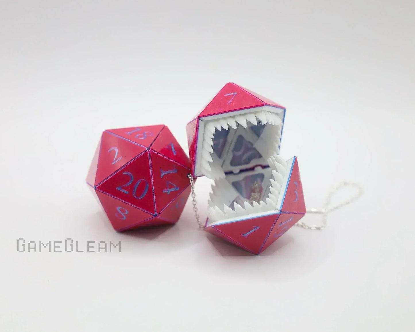 Pink holographic twenty-sided dice with monster mouth design and chain, tabletop gaming accessory