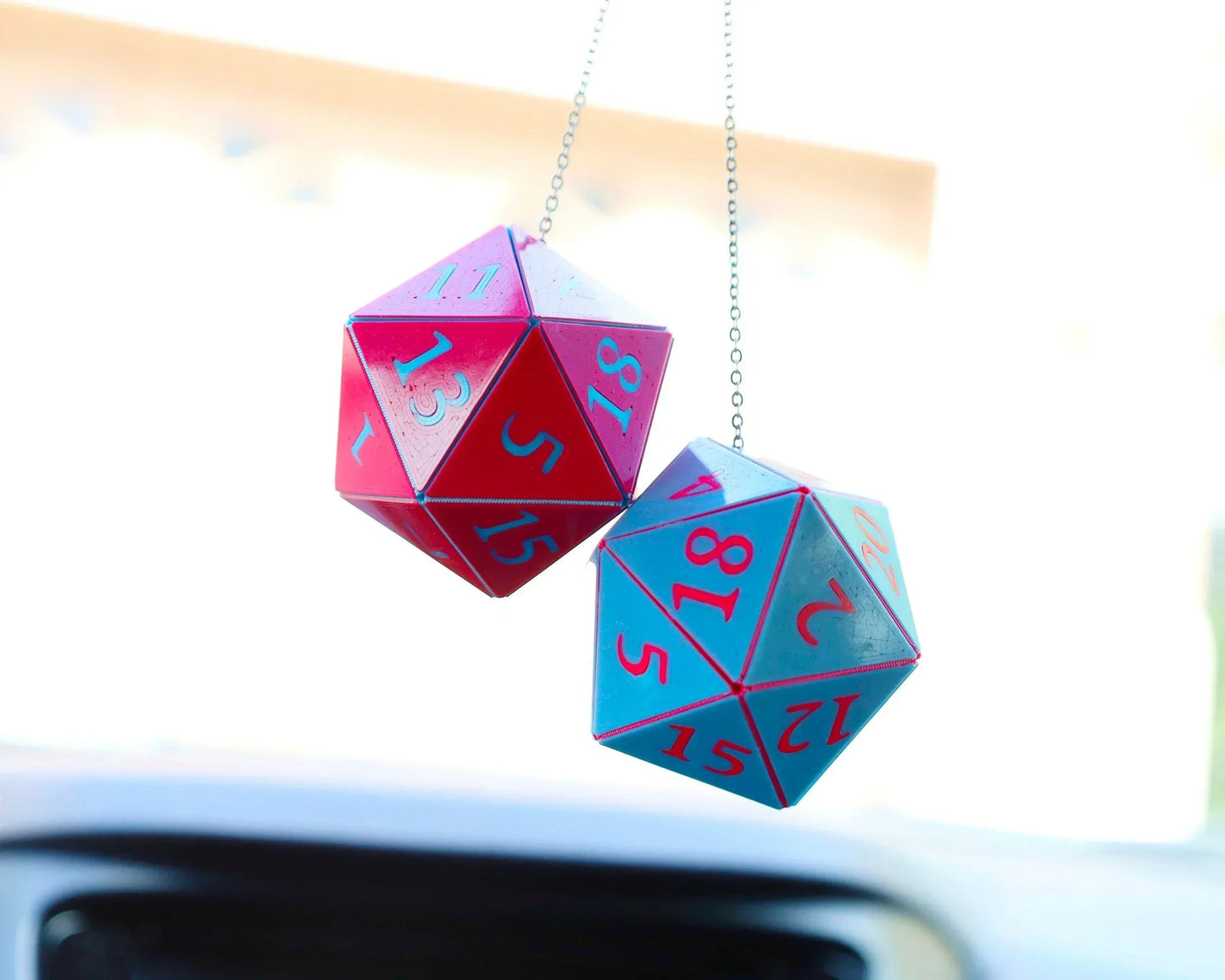 Hanging pink and blue twenty-sided dice car charm for tabletop RPG fans