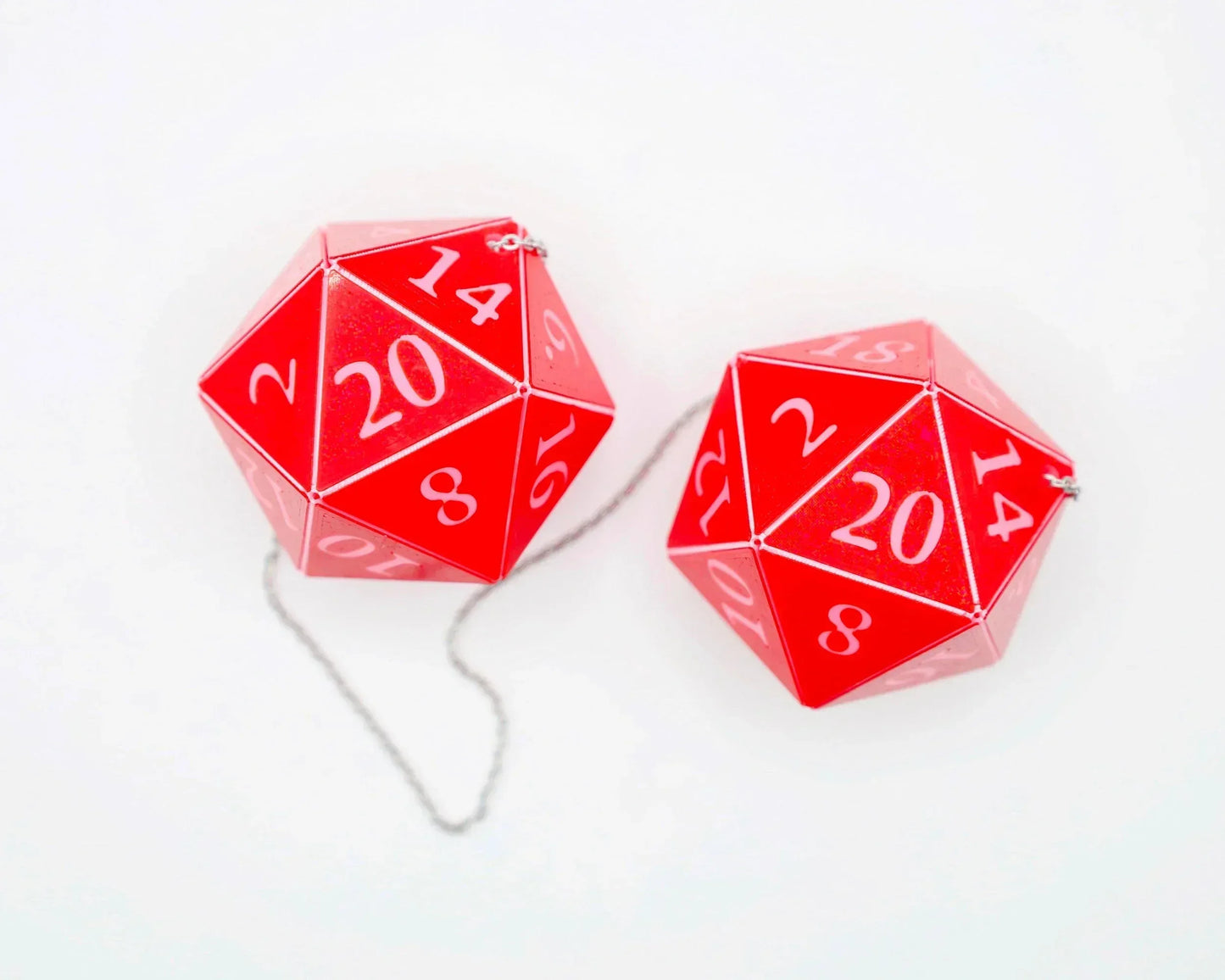 Red twenty-sided dice car charms with white numbers on a white background