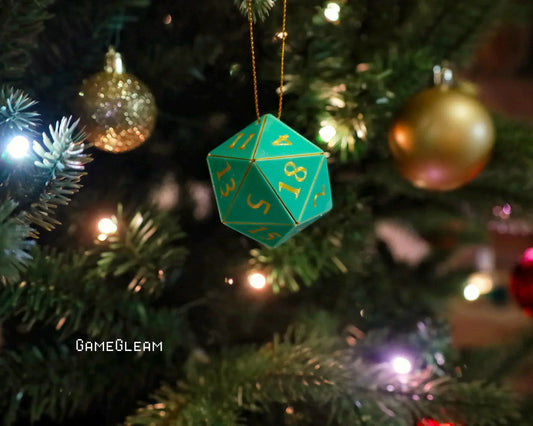 Green twenty-sided dice ornament hanging on a Christmas tree with gold baubles and lights